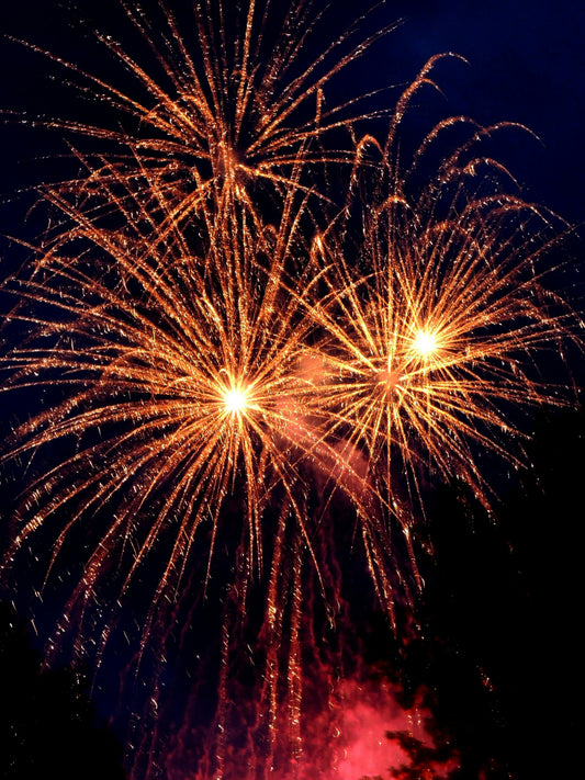 Orange fireworks on dark background celebrating the new year